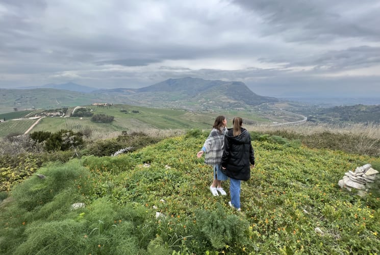 Two students walking in a field.